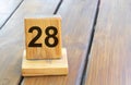 Wooden priority number 28 on a plank tab