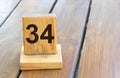 Wooden priority number 34 on a plank tab