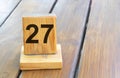 Wooden priority number 27 on a plank tab