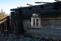 A wooden private house destroyed after a fire. The consequences of a forest fire in the village. Charred walls of a timber house Royalty Free Stock Photo