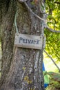 Wooden private sign attached to a tree