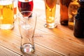 A wooden pub counter, focus on an empty glass of beer Royalty Free Stock Photo