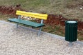 Wooden public bench with same style trash can