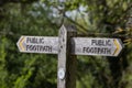 A wooden public footpath sign on a country path