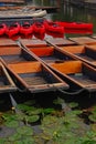 Wooden punt and plastic canoe docked at Cam river, Cambridge