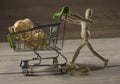 Wooden puppet with shopping cart