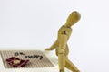 Wooden puppet sitting on a jewellery box Royalty Free Stock Photo