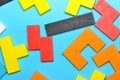 Wooden puzzle on blue background.