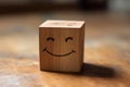 A wooden puzzle cube with a happy face, concept of positive facial emotion Royalty Free Stock Photo