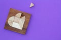 Wooden puzzle details in wooden heart-shaped box with missing piece Royalty Free Stock Photo