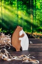 Wooden puzzle in the form of a family of handmade bears on the background of the forest