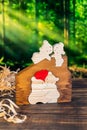 Wooden puzzle in the form of a family of handmade bears on the background of the forest