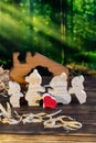 Wooden puzzle in the form of a family of handmade bears on the background of the forest