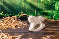 Wooden puzzle in the form of a handmade horse on the background of the forest. Royalty Free Stock Photo