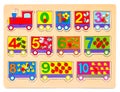 Wooden puzzle in form of train with numbers and arithmetic signs with pictures of items. Children`s hand takes the Royalty Free Stock Photo