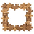Wooden puzzle pieces form a rectangular frame with a central empty space Royalty Free Stock Photo