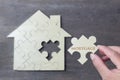 Wooden puzzle wait to fulfill home shape for build dream home, happy life, Royalty Free Stock Photo