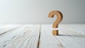 Wooden question mark symbol on white wood surface. Asking, uncertainty concept. FAQ support information. Idea, solution, help, Royalty Free Stock Photo