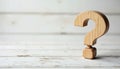 Wooden question mark symbol on white wood surface. Asking, uncertainty concept. FAQ, support, knowledge, solution, help, idea, Royalty Free Stock Photo