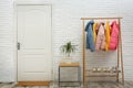 Wooden rack with warm jackets in hallway