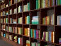 Wooden racks with different books. Library.