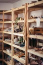 Many different pottery standing on the shelves in a potery workshop