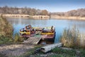 Wooden raft for rest stands at the shore of the reservoir