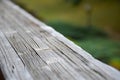 Wooden railing on the terrace outside. Detail on wood. Green landscape in the background