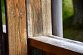 Wooden railing on the terrace outside. Detail on wood. Green landscape in the background