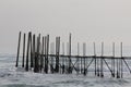 Wooden railings in the sea, sea waves, rough sea with waves Royalty Free Stock Photo