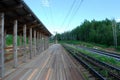 Wooden railway station, railway platform. Rural railway station. Rails and a station in a rural area.