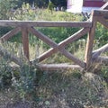 wooden rectangular fence old with overgrown dry grass Royalty Free Stock Photo