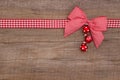 Wooden red christmas background with a white checked ribbon Royalty Free Stock Photo