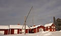 Red wooden historic church houses of Gammelstad near Lulea in winter in Sweden