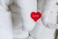 A wooden red heart holding an elephant figurine of a white towel symbol of love composition greeting the newlyweds in a hotel Royalty Free Stock Photo