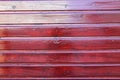 Wooden red horizontal wall facade fence made of planks wood burgundy vertical background Royalty Free Stock Photo