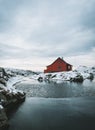 Wooden red house at the sea in Norway on a mountain peak