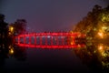 Wooden red-painted The Huc Bridge reflection on Hoan Kiem Lake a Royalty Free Stock Photo