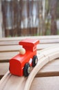 Wooden red toy train on wooden tracks Royalty Free Stock Photo