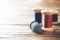 Wooden reel with thread and fingertip close-up. Selective focus. Rendered image. Copy space