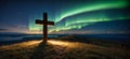 wooden religious cross on the hill with beautiful northern lights