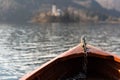 Wooden rent boat on a Bled lake, end of the boat facing towards Lake Bled island - famous tourist destination in