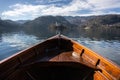 Wooden rent boat, end of the boat facing towards Lake Bled island - copy space and focus on Bled island, tourist