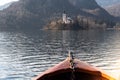 Wooden rent boat, end of the boat facing towards Lake Bled island, focus on Bled island - famous tourist destination in