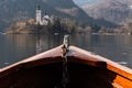 Wooden rent boat, end of the boat facing towards Lake Bled island, focus on boat - famous tourist destination in