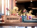 Wooden reserved sign on dining table in restaurant