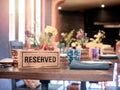 Wooden reserved sign on dining table in restaurant