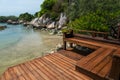 Wooden resort patio and chairs by the sea at Ko Man Klang, Rayong