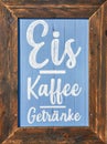 Wooden restaurant sign with offers. Letter with Kaffee Eis GetrÃÂ¤nke means Coffee Ice Drinks