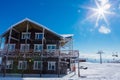 Wooden restaurant on the top of snowy mountains in sunny winter day Royalty Free Stock Photo